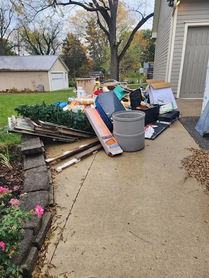 Dumpster being loaded with debris for Estate Cleanout Dumpster Rental in Jenner
